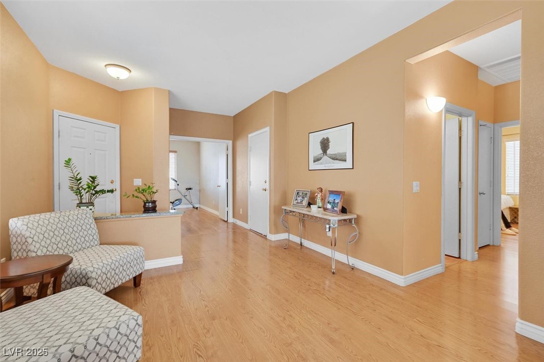 10983 Pumpkin Ridge Avenue Las Vegas, NV 89135 - Photo 5 of 35 Entrance foyer with baseboards, plenty of natural light, and light wood finished floors