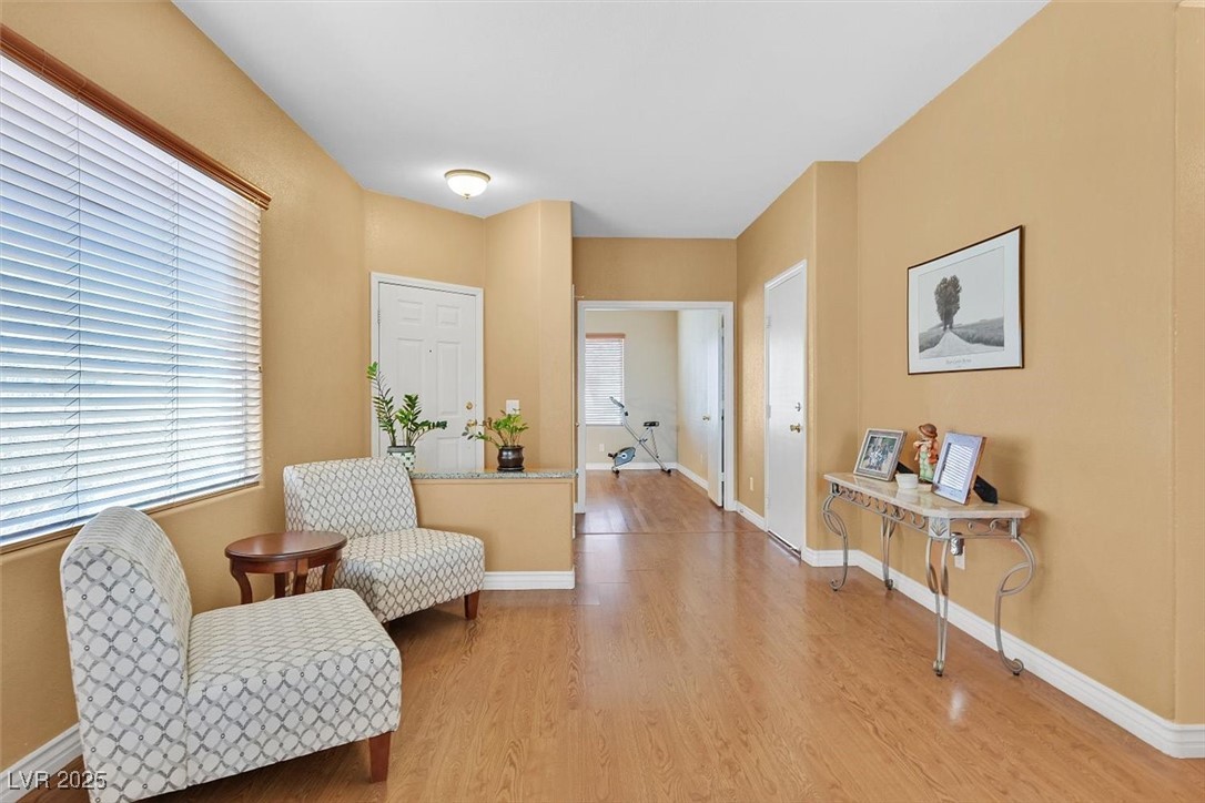 10983 Pumpkin Ridge Avenue Las Vegas, NV 89135 - Photo 6 of 35 Living area with baseboards and light wood finished floors