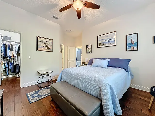 a bed room with a bed and a chair