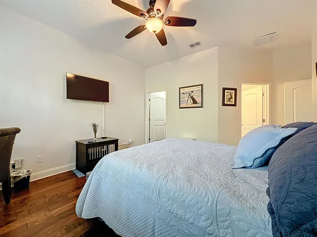 a spacious bedroom with a bed and a chandelier