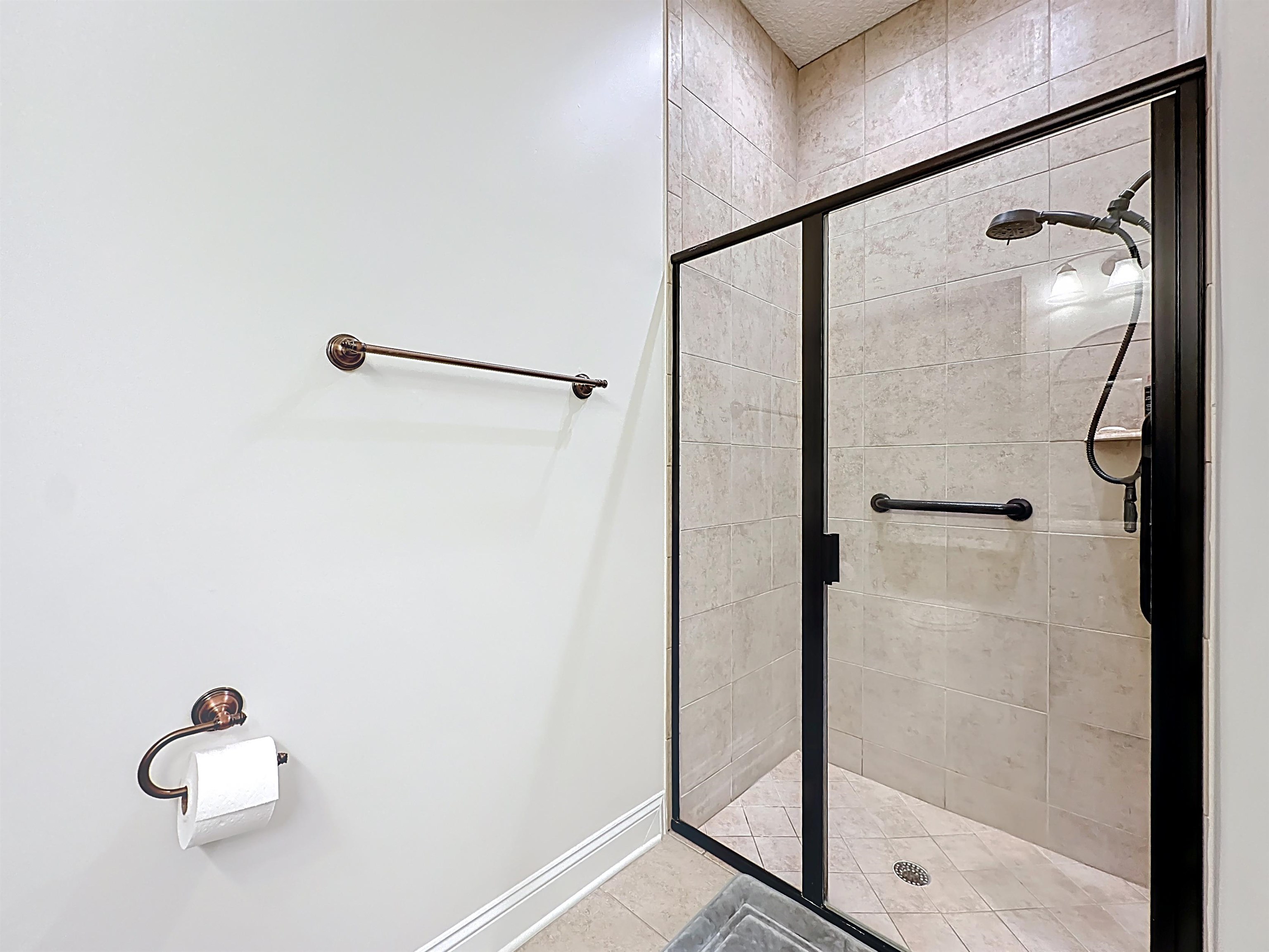 130 Grand Ravine Drive St. Augustine, FL 32086 - Photo 21 of 42 Bathroom featuring a stall shower and baseboards