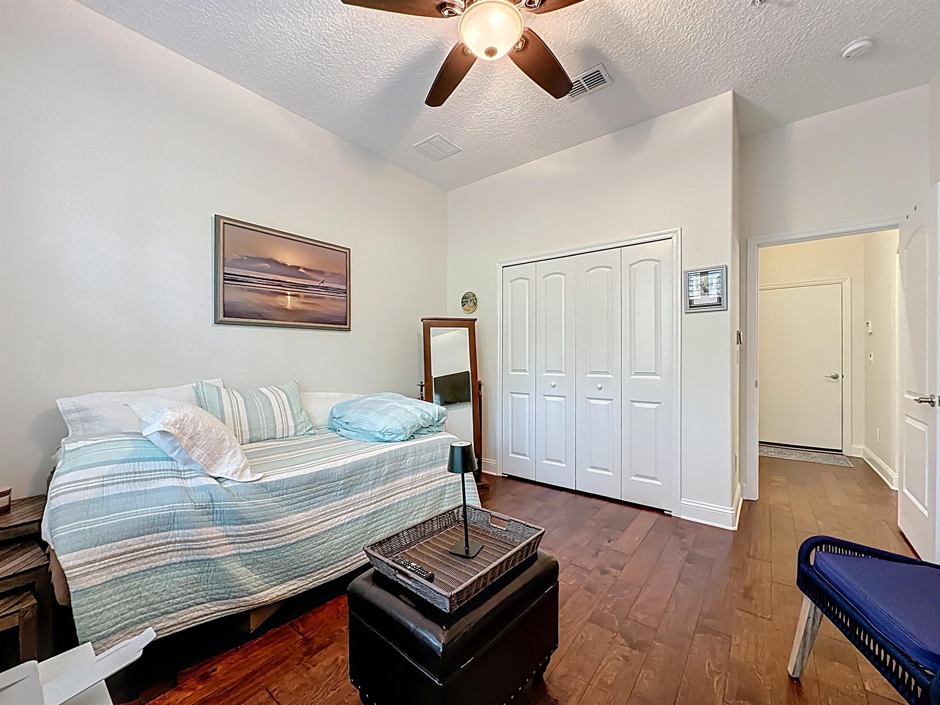 130 Grand Ravine Drive St. Augustine, FL 32086 - Photo 24 of 42 Bedroom with a textured ceiling, ceiling fan, a closet, and dark wood-style floors