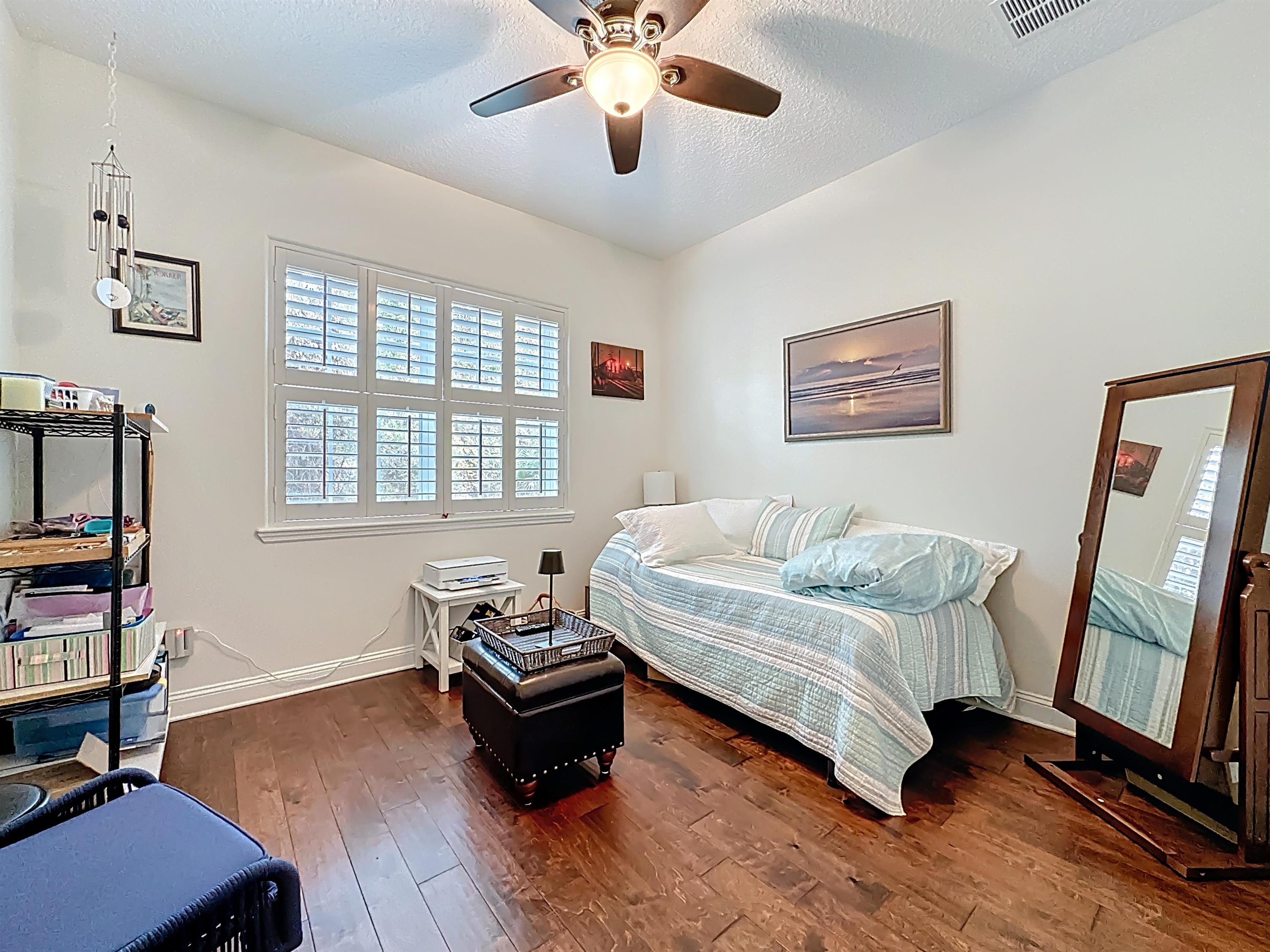 130 Grand Ravine Drive St. Augustine, FL 32086 - Photo 25 of 42 Bedroom with hardwood / wood-style flooring, ceiling fan, and a textured ceiling