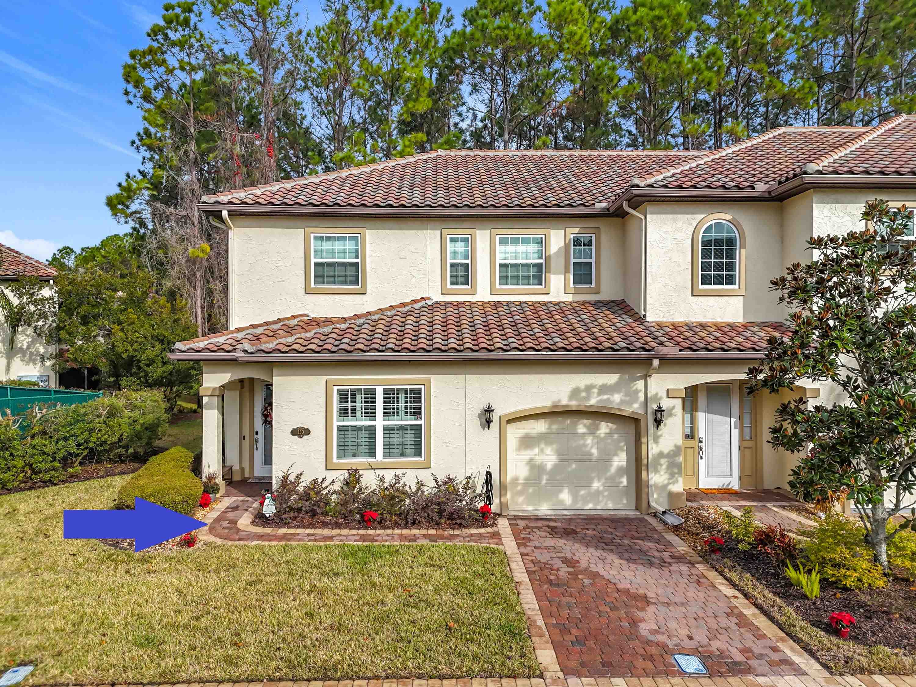 130 Grand Ravine Drive St. Augustine, FL 32086 - Photo 37 of 42 Mediterranean / spanish-style house featuring stucco siding, decorative driveway, a front lawn, a tiled roof, and an attached garage