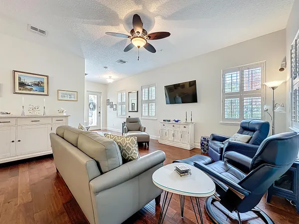 a kitchen with stainless steel appliances a sink cabinets and wooden floor
