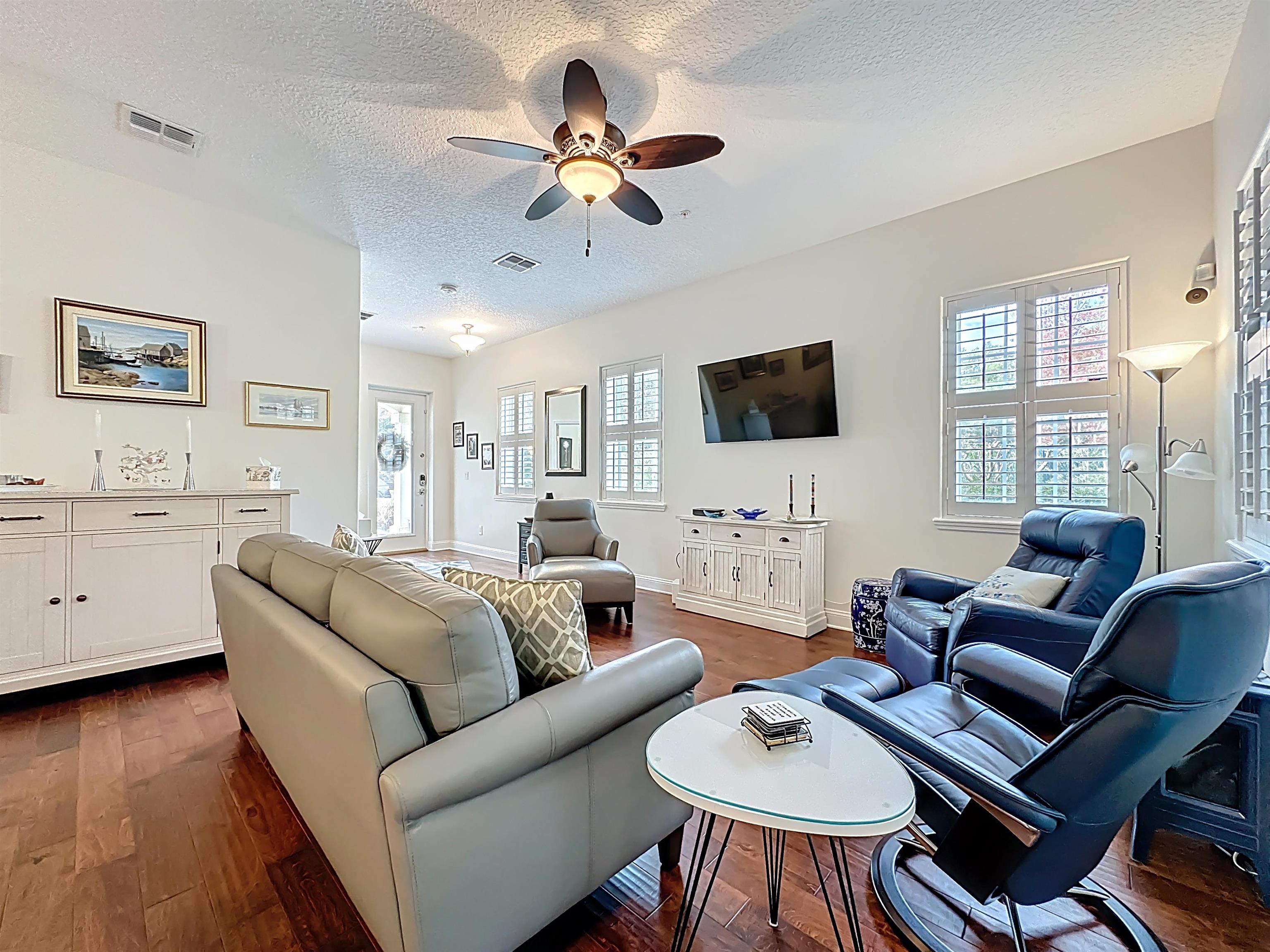 130 Grand Ravine Drive St. Augustine, FL 32086 - Photo 7 of 42 Living area with a textured ceiling, dark wood-style flooring, a ceiling fan, and plenty of natural light