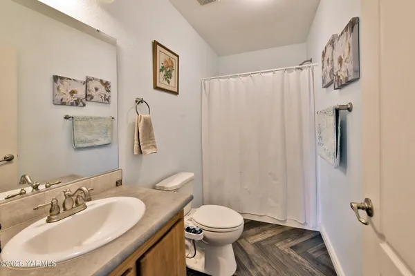a bathroom with a toilet sink and shower
