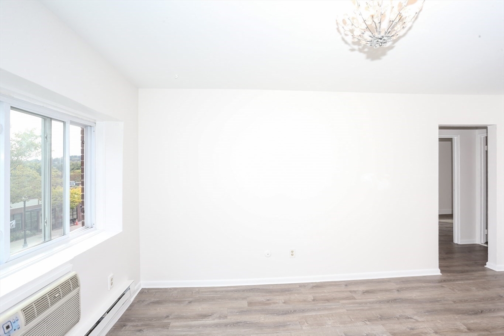 461 Washington Street, Unit 301 Boston, MA 02135 - Photo 11 of 13 a view of wooden floor and windows in a room
