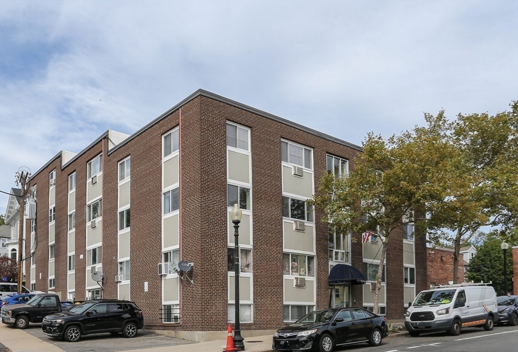 461 Washington Street, Unit 301 Boston, MA 02135 - Photo 13 of 13 a city street lined with buildings and cars