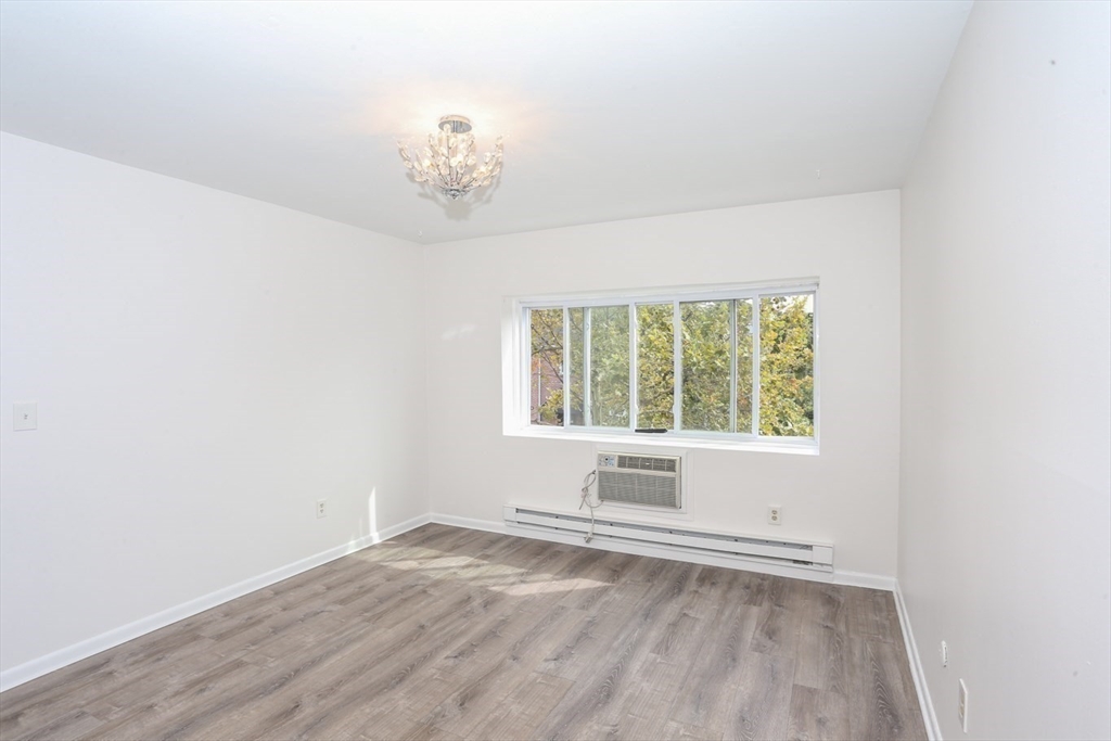 461 Washington Street, Unit 301 Boston, MA 02135 - Photo 3 of 13 an empty room with a window