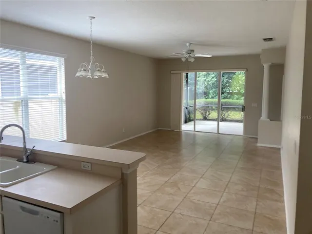 a view of a kitchen with a sink and chandelier