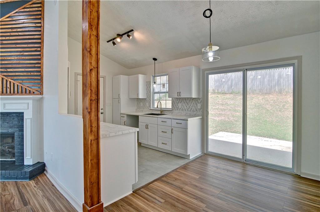 2665 Ivydale Court Southwest Atlanta, GA 30311 - Photo 13 of 45 a kitchen with white cabinets and wooden floor