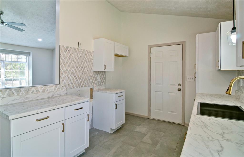 2665 Ivydale Court Southwest Atlanta, GA 30311 - Photo 17 of 45 a spacious bathroom with a granite countertop sink a mirror and a bathtub