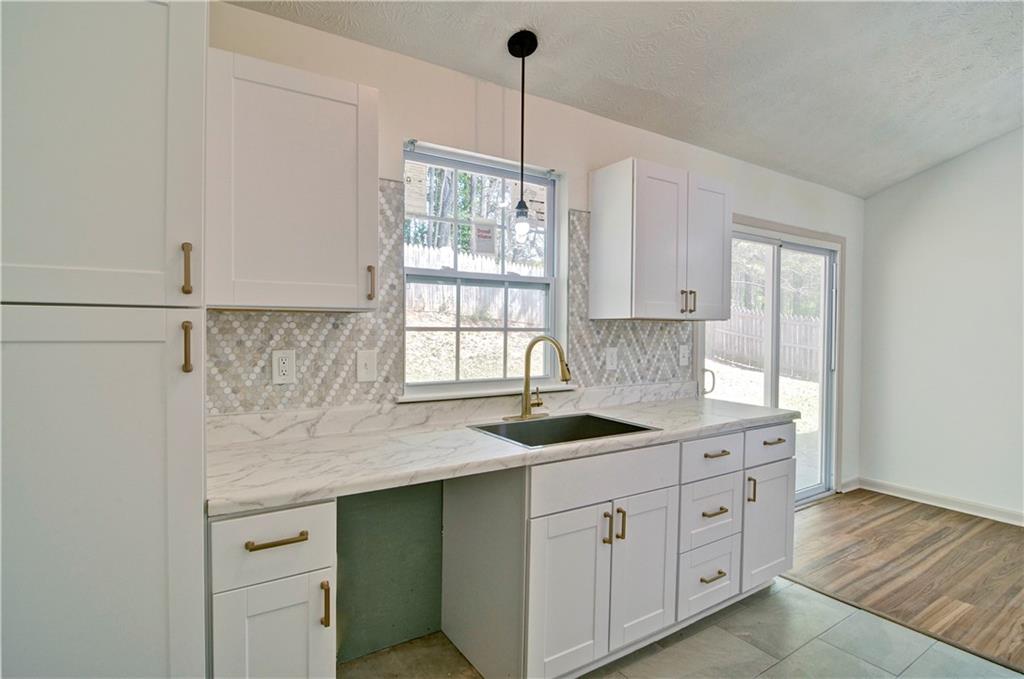 2665 Ivydale Court Southwest Atlanta, GA 30311 - Photo 19 of 45 a kitchen with white cabinets and window