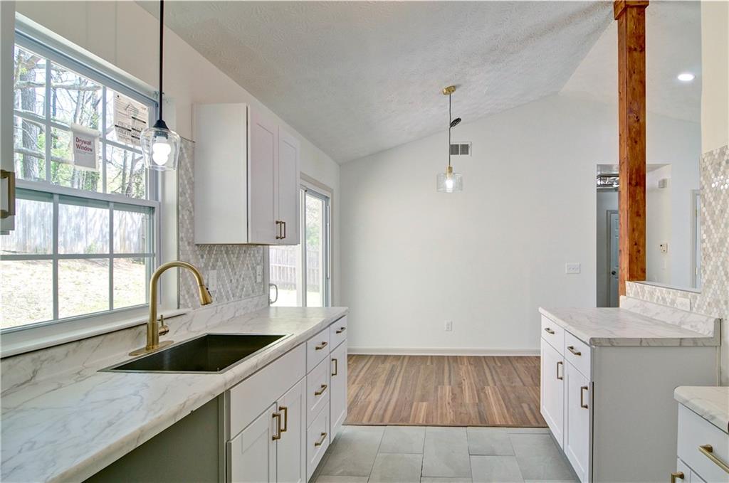 2665 Ivydale Court Southwest Atlanta, GA 30311 - Photo 21 of 45 a kitchen with granite countertop a sink and a window