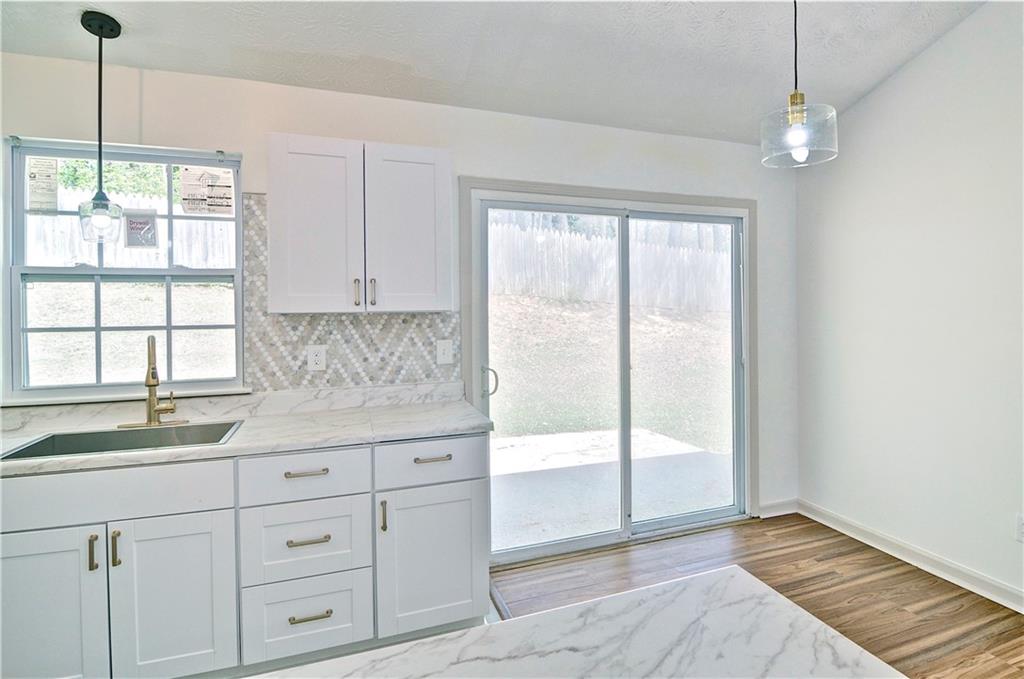 2665 Ivydale Court Southwest Atlanta, GA 30311 - Photo 22 of 45 a kitchen with white cabinets and window