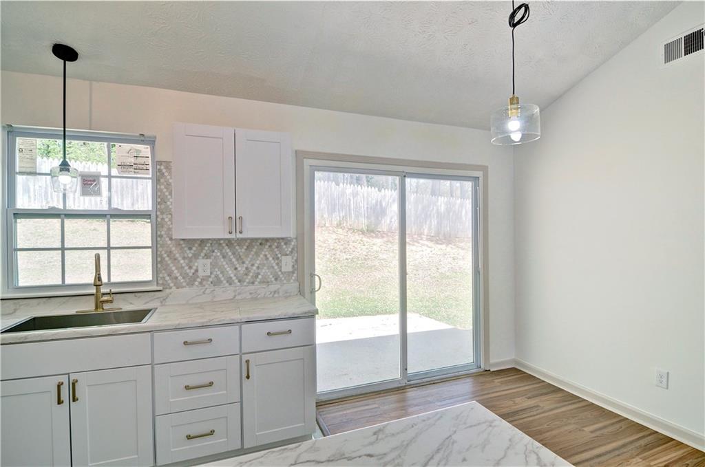 2665 Ivydale Court Southwest Atlanta, GA 30311 - Photo 23 of 45 a kitchen with white cabinets and window