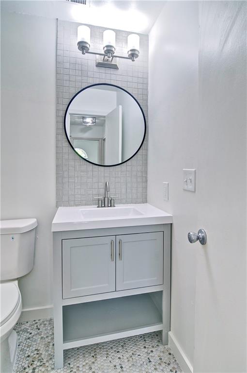 2665 Ivydale Court Southwest Atlanta, GA 30311 - Photo 26 of 45 a bathroom with a sink toilet and mirror
