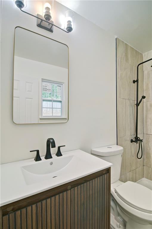 2665 Ivydale Court Southwest Atlanta, GA 30311 - Photo 38 of 45 a bathroom with a sink mirror vanity and toilet