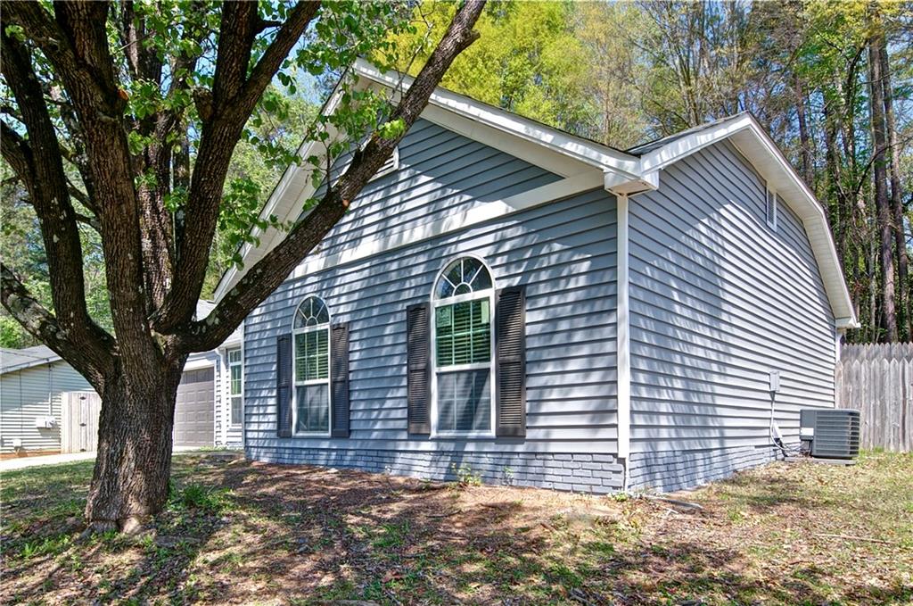 2665 Ivydale Court Southwest Atlanta, GA 30311 - Photo 5 of 45 a front view of a house with a tree
