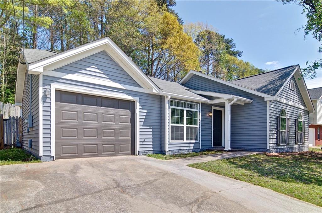 2665 Ivydale Court Southwest Atlanta, GA 30311 - Photo 6 of 45 a front view of a house with a yard and garage
