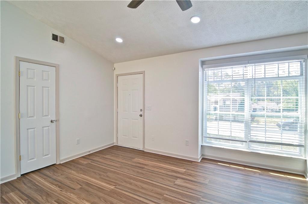 2665 Ivydale Court Southwest Atlanta, GA 30311 - Photo 9 of 45 a view of an empty room with wooden floor and a window