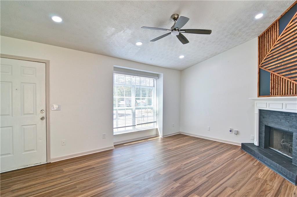 2665 Ivydale Court Southwest Atlanta, GA 30311 - Photo 10 of 45 an empty room with wooden floor fan and windows