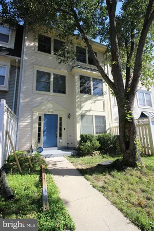 a front view of a house with a yard garage and outdoor seating