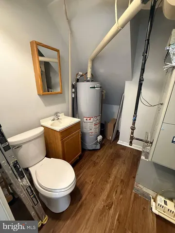 a white toilet sitting next to a bathroom sink