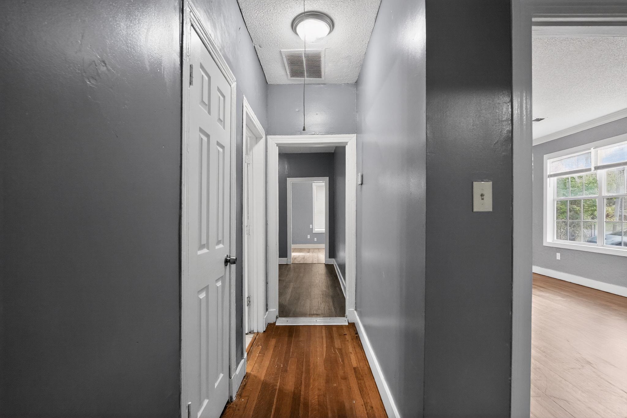 4199 Auburn Road Memphis, TN 38116 - Photo 28 of 32 Hallway featuring wood-finish flooring and neutral-toned walls