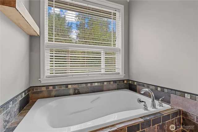 a bathroom with a bathtub and a window