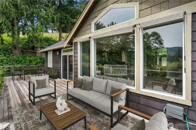 a living room with furniture a table and a floor to ceiling window