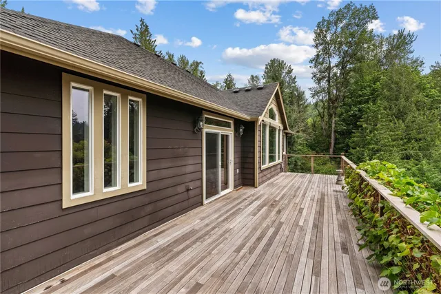 a view of backyard with deck and wooden floor