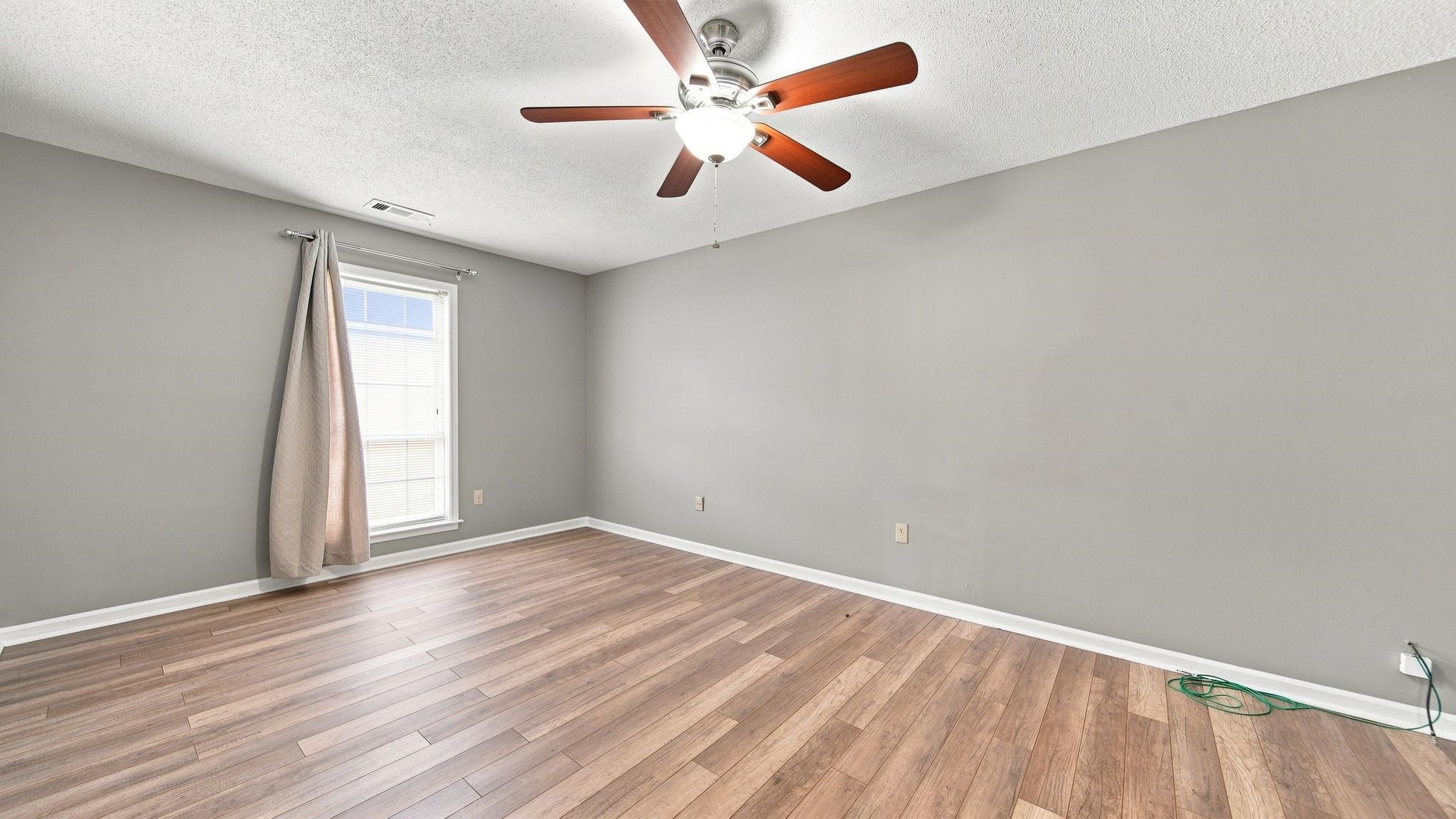 4920 Whitworth Road Memphis, TN 38116 - Photo 17 of 32 Recessed window with white trim, wood-finish flooring, ceiling fan with light fixture, and neutral painted walls