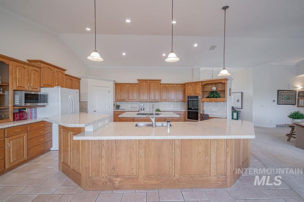 2700 North River Road St. Anthony, ID 83445 - Photo 15 of 50 The kitchen features an expansive granite island that provides ample space for counter-height chairs/stools, making it easy to chat with guests or family members while preparing meals.