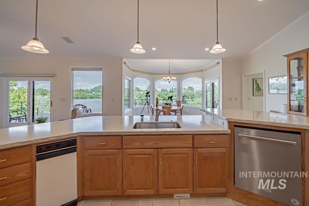 2700 North River Road St. Anthony, ID 83445 - Photo 17 of 50 The stunning views of the river from the kitchen enhance both the cooking and the dining experience. Note Trash Compactor to left, Dishwasher to right.