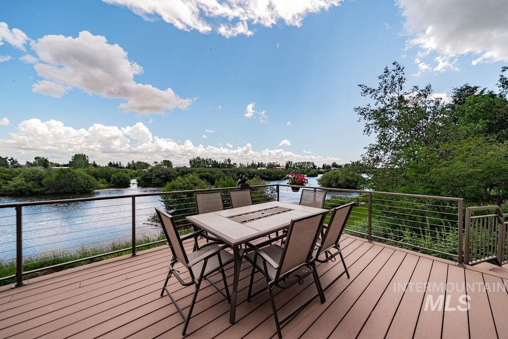 2700 North River Road St. Anthony, ID 83445 - Photo 20 of 50 The dining room door opens to a spacious deck overlooking the river, perfect for outdoor dining. The deck also features stairs that lead directly down to the river for easy access.