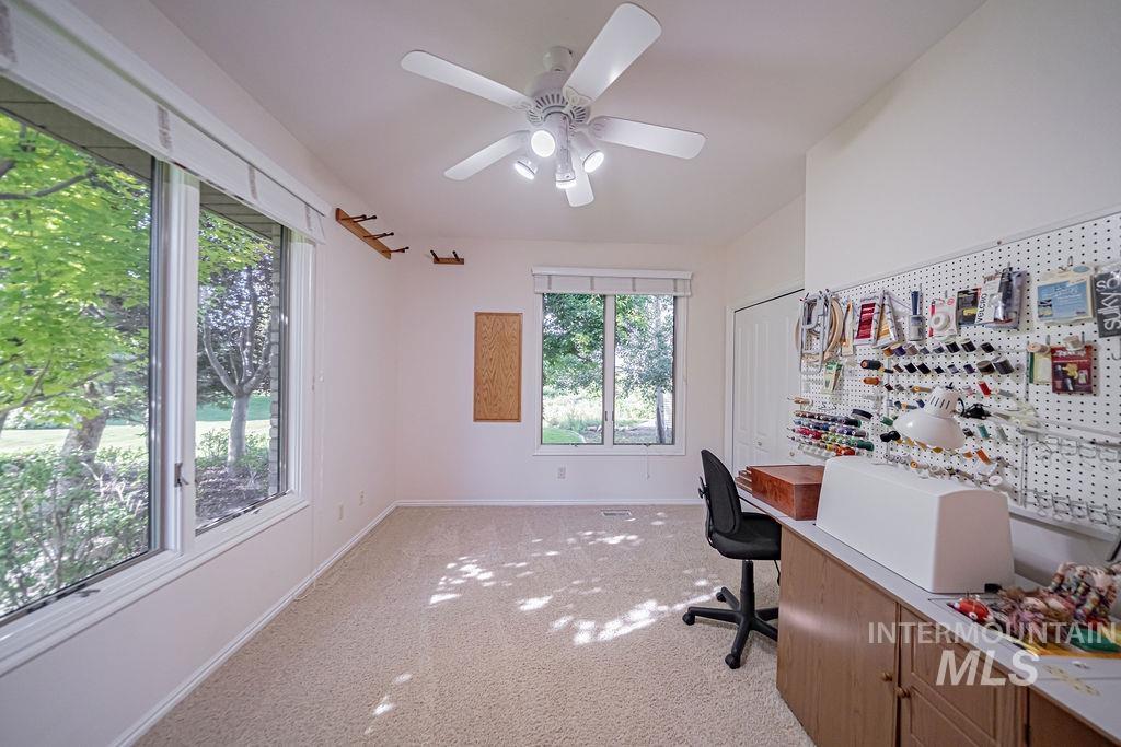 2700 North River Road St. Anthony, ID 83445 - Photo 29 of 50 Currently a sewing room, this spacious bedroom has large viewing windows overlooking the yard & flower garden. It also features blinds for privacy & light control, plus and a ceiling fan, closet with built-ins.