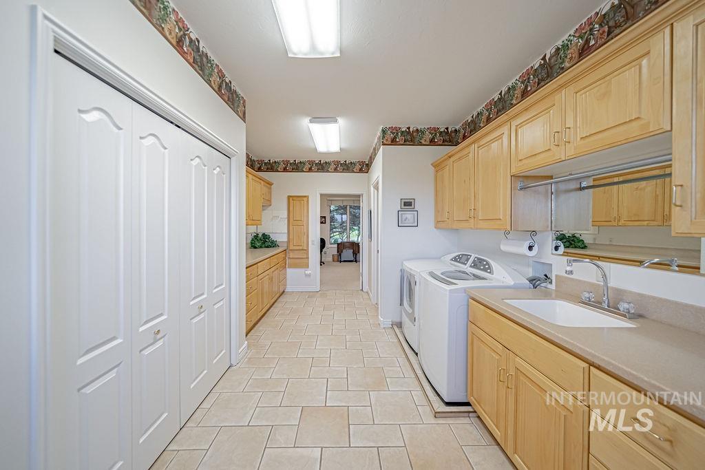 2700 North River Road St. Anthony, ID 83445 - Photo 31 of 50 This laundry/mudroom area boasts ½ bath, sink, ironing board, ample cabinets/counter space, large closet with build-in drawers/shelves. The Washer and Dryer are included.