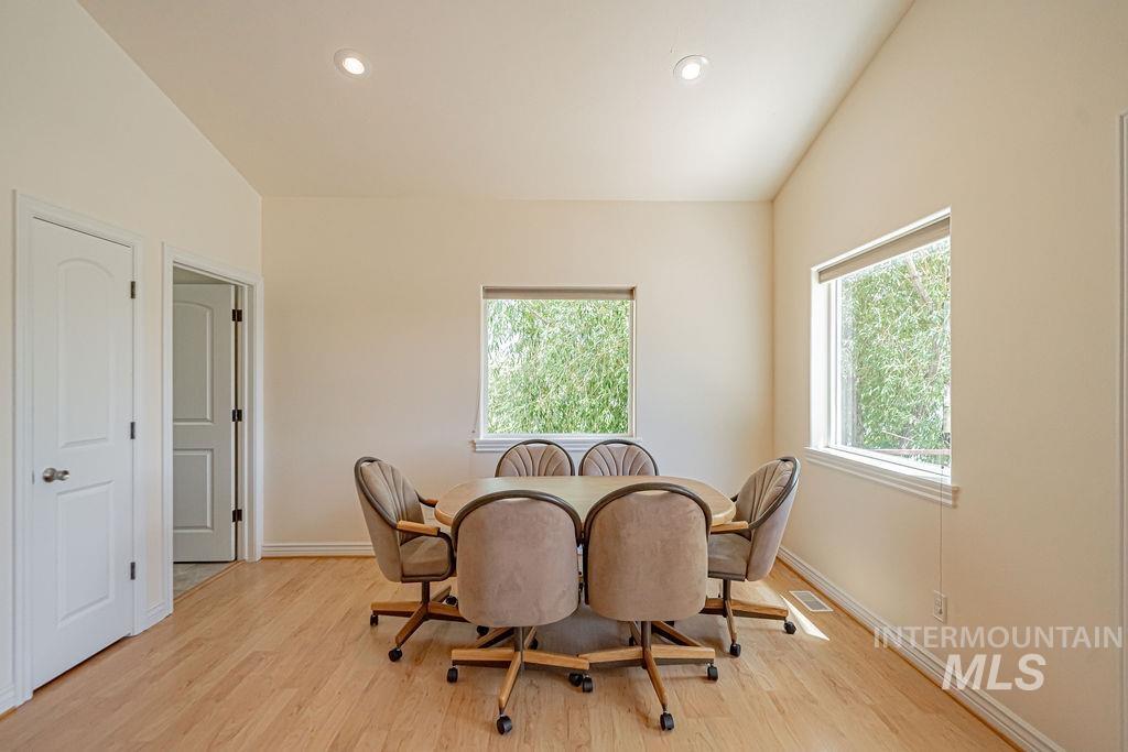 2700 North River Road St. Anthony, ID 83445 - Photo 40 of 50 Dining space featuring vaulted ceiling, LVP flooring, recessed lighting, plenty of natural light, and gorgeous river views.