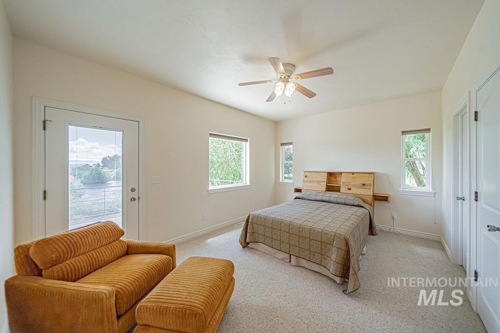 2700 North River Road St. Anthony, ID 83445 - Photo 41 of 50 Bedroom features access to outside deck area, walk-in closet, and bathroom access.