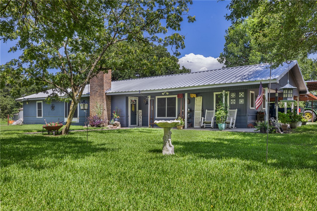 a front view of a house with a garden and porch