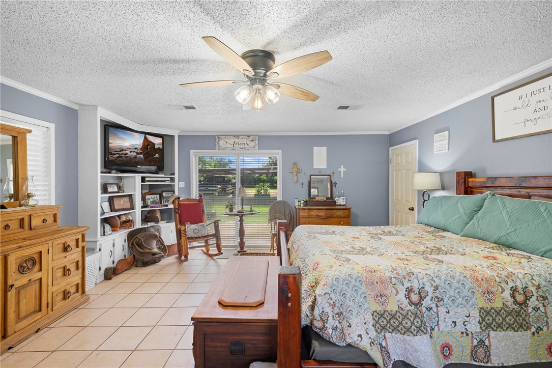 4450 Greenbriar Road Madisonville, TX 77864 - Photo 15 of 27 a bedroom with a bed and a large window