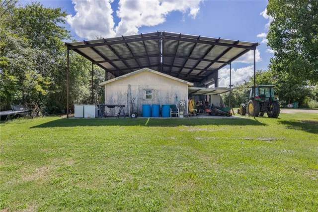 a view of a house with a backyard