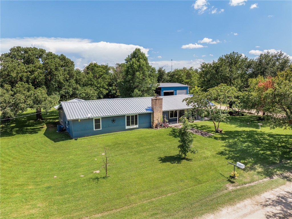 4450 Greenbriar Road Madisonville, TX 77864 - Photo 2 of 27 a house view with a garden space