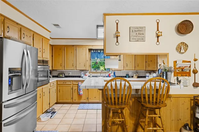 a kitchen with stainless steel appliances granite countertop a sink and a refrigerator