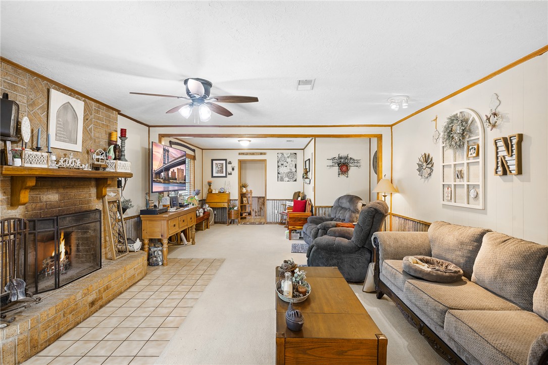 4450 Greenbriar Road Madisonville, TX 77864 - Photo 9 of 27 a living room with furniture ceiling fan and a fireplace