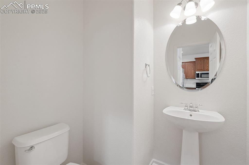 1243 Timber Run Heights Monument, CO 80132 - Photo 14 of 34 a bathroom with a toilet sink and mirror