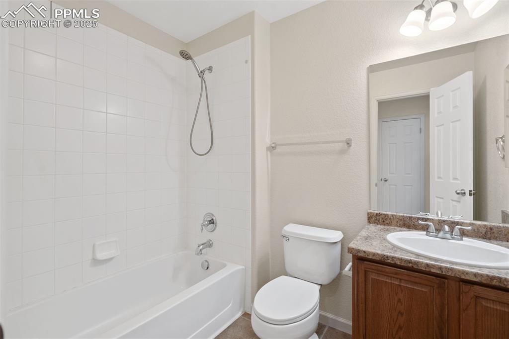 1243 Timber Run Heights Monument, CO 80132 - Photo 23 of 34 a bathroom with a granite countertop toilet a sink and a bathtub
