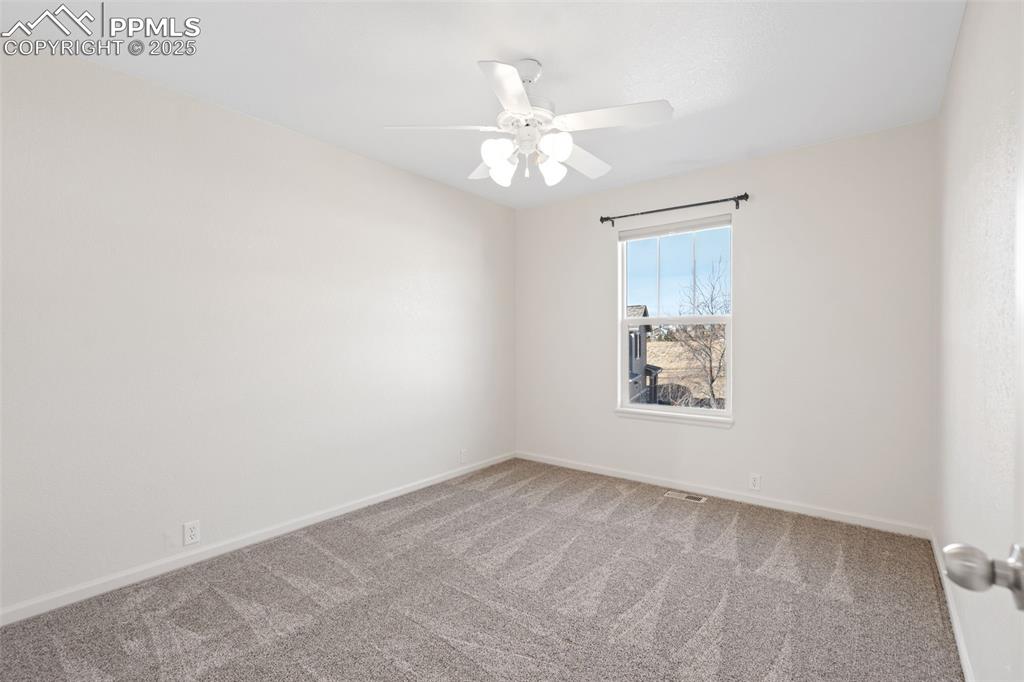 1243 Timber Run Heights Monument, CO 80132 - Photo 34 of 34 an empty room with a window and a fan